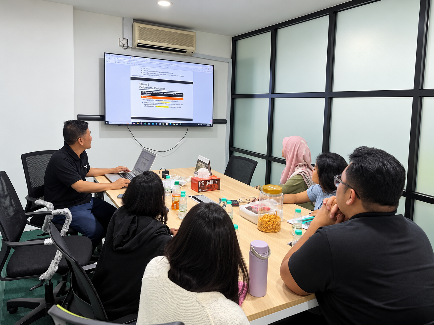 ISO training session with participants reviewing presentation material